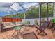 Inviting screened-in patio with a hot tub, comfortable seating, and a lush, green backdrop for relaxation and entertainment at 205 Bengal Cir, Oldsmar, FL 34677