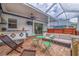 Spacious screened-in patio featuring an outdoor kitchen, hot tub, and comfortable seating for year-round enjoyment at 205 Bengal Cir, Oldsmar, FL 34677