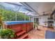 Relaxing screened-in outdoor space with a hot tub, covered patio, and built-in barbecue area, perfect for entertaining at 205 Bengal Cir, Oldsmar, FL 34677