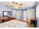 Blue primary bedroom featuring a closet, wood furniture, and an ensuite bathroom at 5728 Colonial Dr, New Port Richey, FL 34653