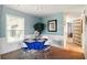 Bright dining area featuring a round table with seating for four, complemented by wainscoting and a large window at 5728 Colonial Dr, New Port Richey, FL 34653