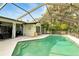 This in-ground swimming pool is surrounded by a screened enclosure, offering privacy and protection at 5728 Colonial Dr, New Port Richey, FL 34653