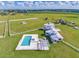 Expansive property showcasing a luxurious pool, manicured lawns, and a beautifully designed home at 15200 Rawls Rd, Sarasota, FL 34240
