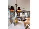 Sunlit dining area featuring hardwood floors, vintage decor, chandelier lighting, and cozy ambiance at 15200 Rawls Rd, Sarasota, FL 34240