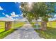 Metal gate leading to the property with an elegant brick entrance at 15200 Rawls Rd, Sarasota, FL 34240