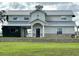 Charming two-story home with a metal roof and well-maintained landscaping, exuding curb appeal at 15200 Rawls Rd, Sarasota, FL 34240