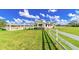 Exterior view of the building featuring large grassy field and white fencing at 15200 Rawls Rd, Sarasota, FL 34240