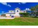 Exterior featuring a car port, brick accents, and green vines growing on the building at 15200 Rawls Rd, Sarasota, FL 34240