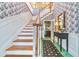 Foyer featuring a wooden staircase and decorative wallpaper at 15200 Rawls Rd, Sarasota, FL 34240