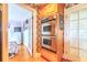 Kitchen with stainless steel double ovens and hardwood floors at 15200 Rawls Rd, Sarasota, FL 34240