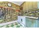 The laundry room offers a washing machine, sink, and vintage wallpaper at 15200 Rawls Rd, Sarasota, FL 34240