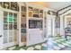 The living room features beautiful built-in shelves, checkered floors, and vintage-style wallpaper at 15200 Rawls Rd, Sarasota, FL 34240