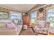 Inviting living room with classic floral wallpaper, hardwood floors and natural light at 15200 Rawls Rd, Sarasota, FL 34240