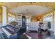 A large main bedroom offers a piano, seating area, patterned wallpaper and a four-poster bed at 15200 Rawls Rd, Sarasota, FL 34240