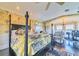 A luxurious main bedroom with a four-poster bed and a seating area with floral accents at 15200 Rawls Rd, Sarasota, FL 34240