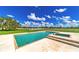 Swimming pool with a spa overlooking manicured backyard and pasture at 15200 Rawls Rd, Sarasota, FL 34240
