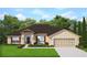 Charming one-story home featuring neutral paint, attached two-car garage, and well-manicured lawn at 2612 Glenridge Dr, Spring Hill, FL 34609