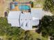 Aerial view of the home showcasing a private pool, screened-in patio, and well-maintained roof at 10230 289Th E St, Myakka City, FL 34251