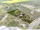 Expansive aerial view of a private property featuring a pond and mature trees at 10230 289Th E St, Myakka City, FL 34251