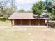 The barn exterior shows a rustic barn with brown wood and a roof at 10230 289Th E St, Myakka City, FL 34251