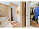 Bathroom with walk-in closet, tub, and shower at 10230 289Th E St, Myakka City, FL 34251