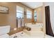 Bathroom with corner tub, tile floors, and natural light at 10230 289Th E St, Myakka City, FL 34251