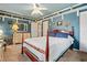 Charming bedroom showcasing a four-poster bed, cool blue walls, and decorative shelving with character at 10230 289Th E St, Myakka City, FL 34251