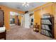 Cozy bedroom featuring brown carpet, orange walls, and built-in storage shelves for ultimate organization at 10230 289Th E St, Myakka City, FL 34251