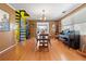 Spacious dining room with hardwood floors, spiral staircase, and vintage chandelier at 10230 289Th E St, Myakka City, FL 34251