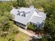 Elevated exterior view showcasing the home's architecture and surrounding mature trees at 10230 289Th E St, Myakka City, FL 34251