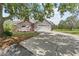 Charming home with a two-car garage and a long driveway lined by a mature tree at 10230 289Th E St, Myakka City, FL 34251