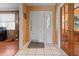 Inviting foyer with white tile flooring, decorative front door, and adjacent living spaces at 10230 289Th E St, Myakka City, FL 34251