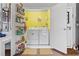 Efficient laundry room with washer, dryer, and storage shelves for organization at 10230 289Th E St, Myakka City, FL 34251