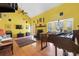 Open living room featuring hardwood floors, piano, fireplace, and large windows at 10230 289Th E St, Myakka City, FL 34251
