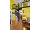Bright living room showcases a unique spiral staircase and hardwood floors at 10230 289Th E St, Myakka City, FL 34251