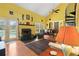 Living room with fireplace, piano, and view of the pool through glass doors at 10230 289Th E St, Myakka City, FL 34251