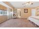 Bright main bedroom featuring a cozy chair and neutral decor at 10230 289Th E St, Myakka City, FL 34251