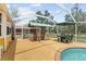 Relaxing pool area with a tiki bar and a patio table set to enjoy the outdoors in comfort at 10230 289Th E St, Myakka City, FL 34251