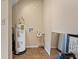 Compact utility room with water heater and flooring at 10230 289Th E St, Myakka City, FL 34251