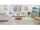 Bright living room featuring a white sofa, round ottoman, and decorative rug creating an inviting space at 10401 Tucker Rd, Weeki Wachee, FL 34613