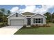 Charming single-Gathering home featuring a two-car garage, manicured lawn, and stone accents at 10434 Tucker Rd, Weeki Wachee, FL 34613