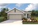 Charming single-story home featuring a neutral color palette, stone accents, and a two-car garage, set in a landscaped yard at 10452 Tucker Rd, Weeki Wachee, FL 34613