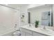 Bright bathroom features double sinks, white cabinets and countertop, and a shower-over-tub at 10460 Tucker Rd, Weeki Wachee, FL 34613