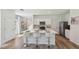 Modern kitchen featuring white cabinets, a large island with seating, and stainless steel appliances at 10460 Tucker Rd, Weeki Wachee, FL 34613