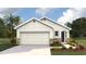 Charming one-story home with stone accents, a two-car garage, and lush landscaping at 10476 Tucker Rd, Weeki Wachee, FL 34613