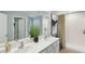 Bathroom featuring double sinks, a large mirror, and a shower with modern fixtures at 10492 Tucker Rd, Weeki Wachee, FL 34613