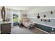 Cozy bedroom with a twin bed, neutral color scheme, and a view of the outdoors at 10492 Tucker Rd, Weeki Wachee, FL 34613