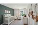 Charming Bedroom with crib, changing table, and serene decor, perfect for your little one at 10492 Tucker Rd, Weeki Wachee, FL 34613