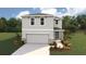 Charming two-story home with landscaped yard and attached two-car garage, perfect for a growing Gathering at 10492 Tucker Rd, Weeki Wachee, FL 34613