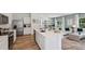 Modern kitchen with stainless steel appliances and a large island, seamlessly flowing into the living room at 10492 Tucker Rd, Weeki Wachee, FL 34613